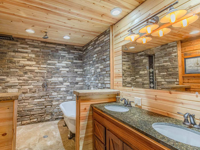 There are three full bathrooms with stone brick walls in the converted barn.