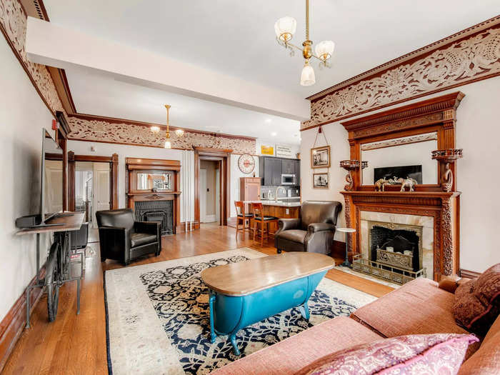 The living room features a fireplace that was hand-carved in England.