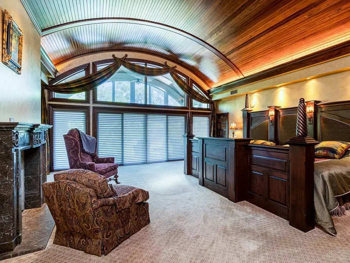 The master bedroom has a wood-barrel ceiling that