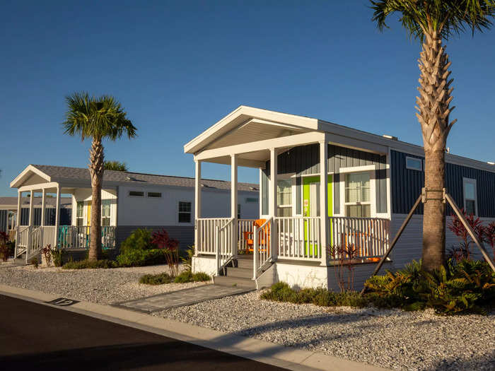 Small palm trees, shrubs, and pebbled parking spots separate the seemingly never-ending row of 60 neutral-colored cabins.