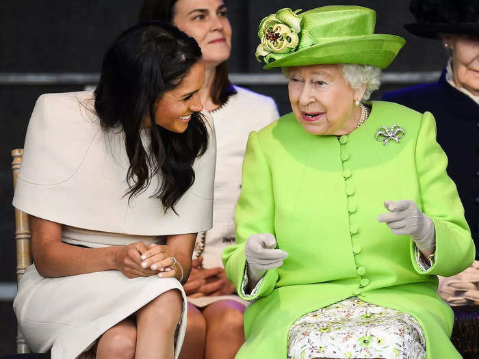 Queen Elizabeth is pictured here laughing with Meghan Markle in June 2018.