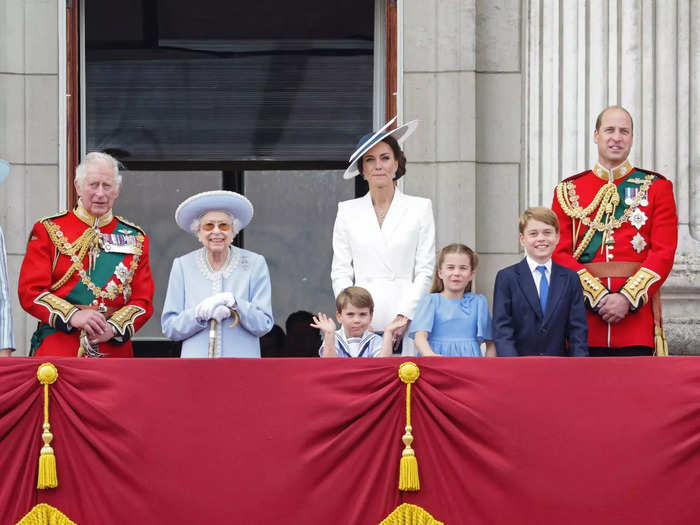 As photographers snapped pictures of the royal family, Prince Louis shrugged unhappily.