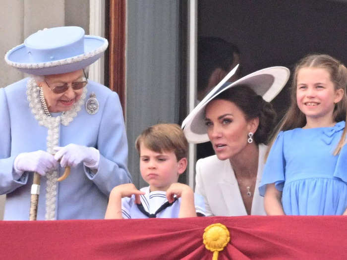 Eventually, Queen Elizabeth leaned down to chat with the young prince as he continued to frown.