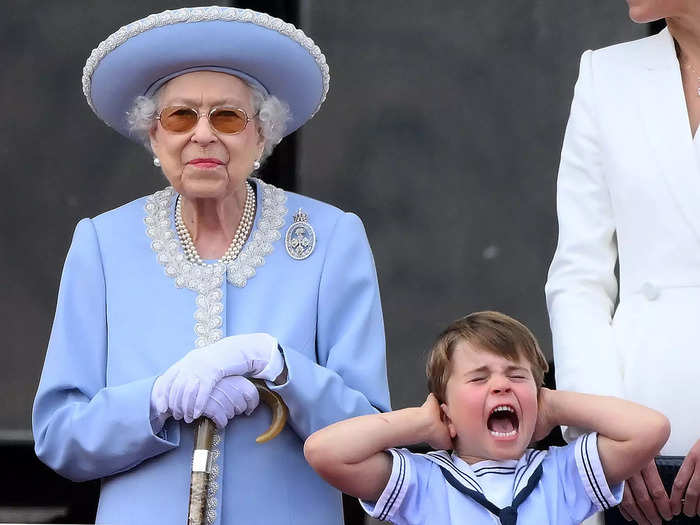 The young prince screamed and covered his ears while he stood next to his great-grandmother.