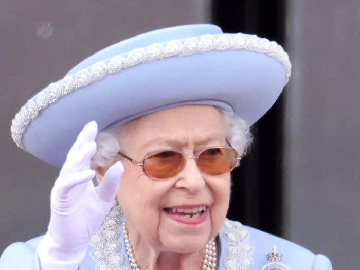 The Queen paired her powder-blue suit with orange sunglasses.