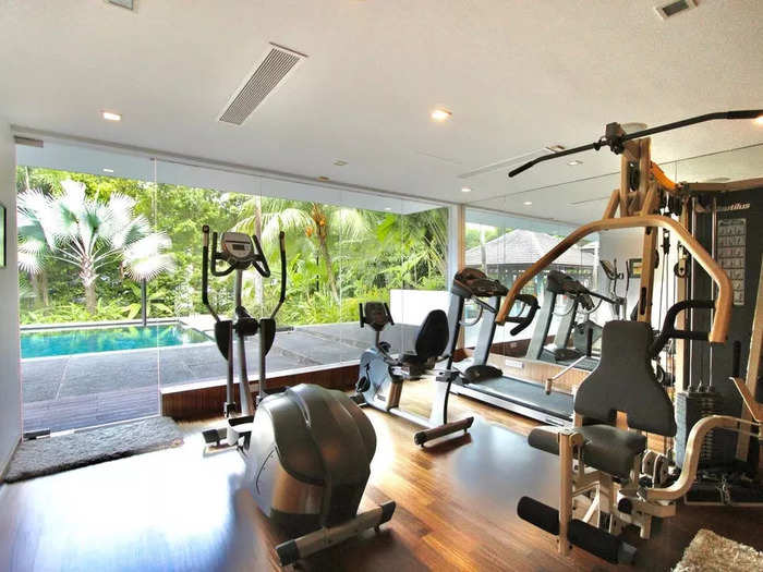 Overlooking the swimming pool is a gym with an adjoining sauna room.