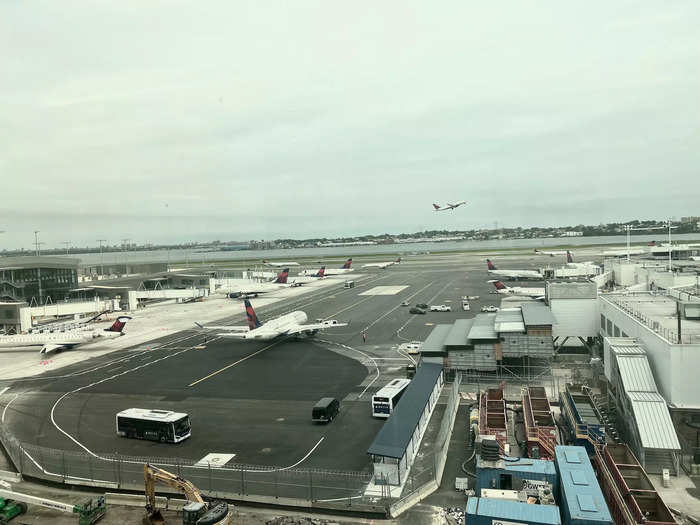 Along the back wall is a long panel of windows that overlook the airfield, giving passengers a bird