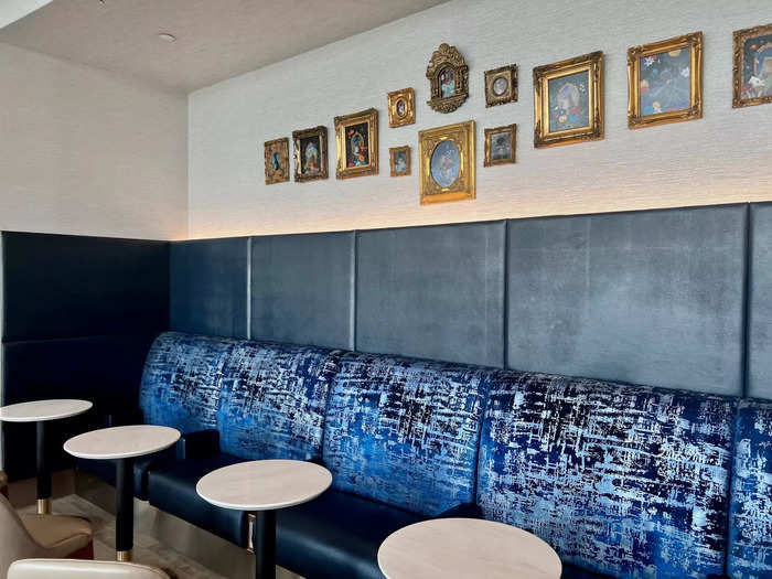 There is also a long couch-like seat towards the back of the lounge, which was my favorite because of the beautiful blue design and framed photos above.