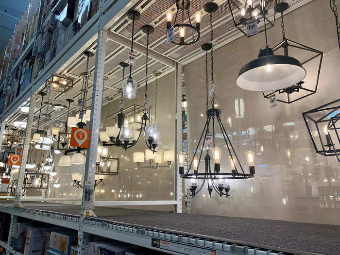 Besides standard light bulbs, all different kinds of light fixtures hang from the tall shelves on display.