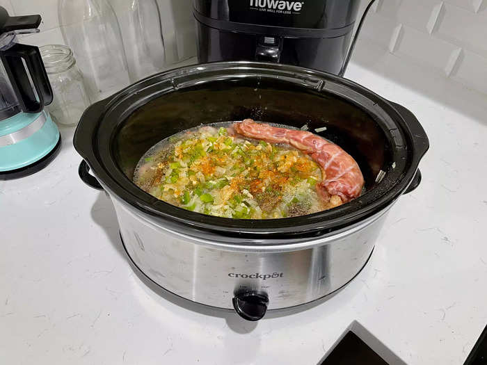 The final additions include seasonings and a turkey neck. Then let the slow cooker do its thing!