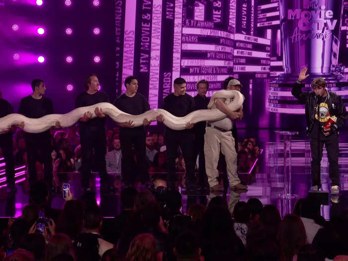 "Jackass" star Sean "Poopies" McInerney kissed a huge python live on stage after winning the Best Kiss Award.