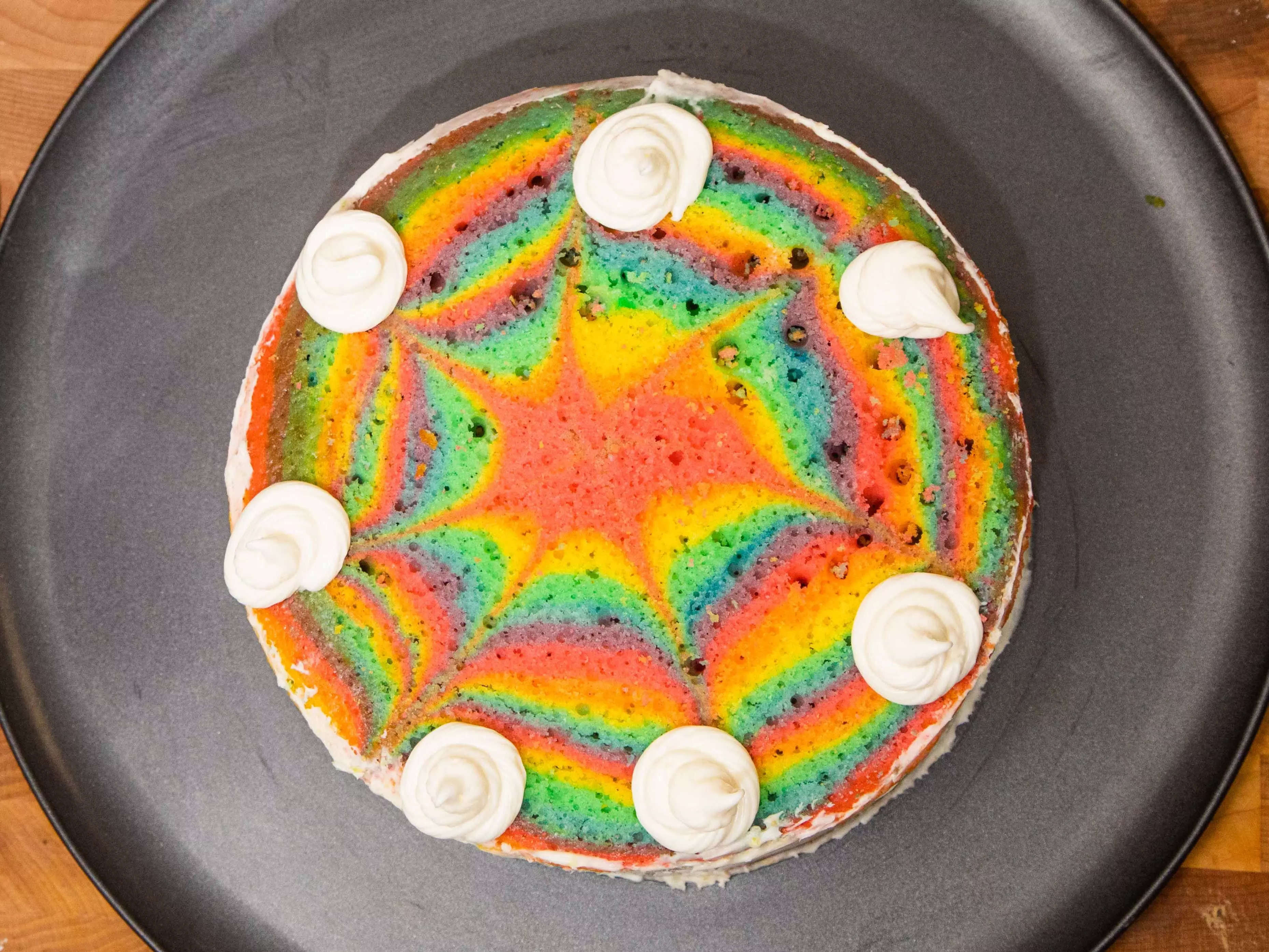 an overhead shot of a tie dye rainbow cake