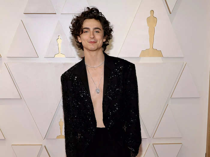 The "Dune" star skipped a shirt at the 2022 Oscars, instead wearing a sequined black blazer and a low-hanging necklace on March 27.