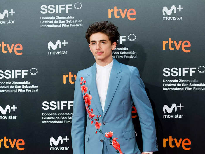 At the San Sebastian International Film Festival a few weeks later, Chalamet wore a sky-blue suit with embroidered red cherry blossoms and a bird across the jacket and leg.