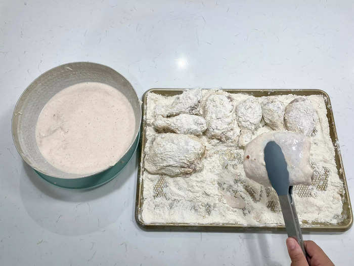 Roll the chicken thighs and drumsticks in the flour mixture to cover every nook and cranny.