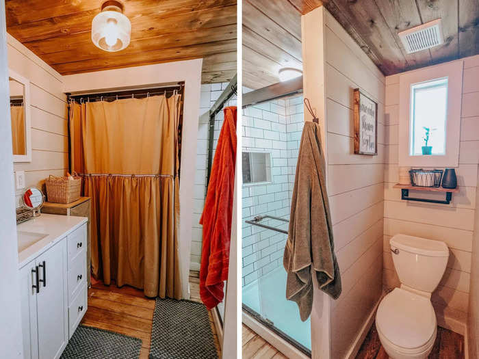 The bathroom has a shower, a toilet, a vanity, and a closet hidden behind a curtain.