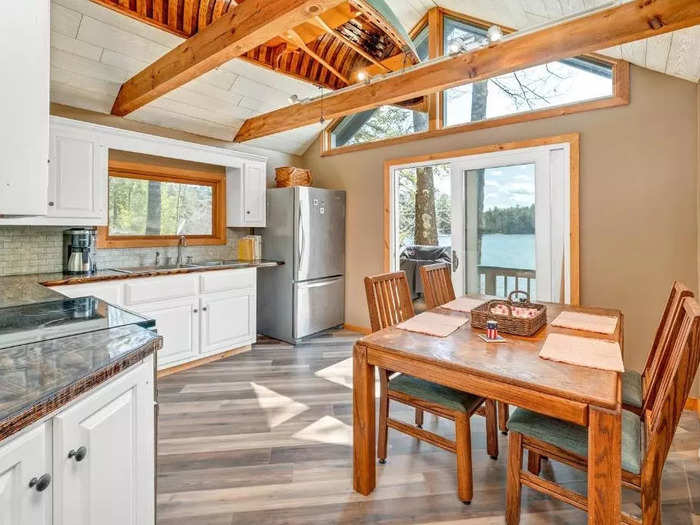 A small dining area is located within the kitchen, which features beamed ceilings and a skylight.