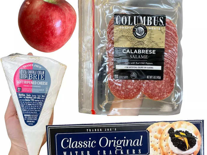 Crackers with cheese, salami, and apples are both sweet and salty.