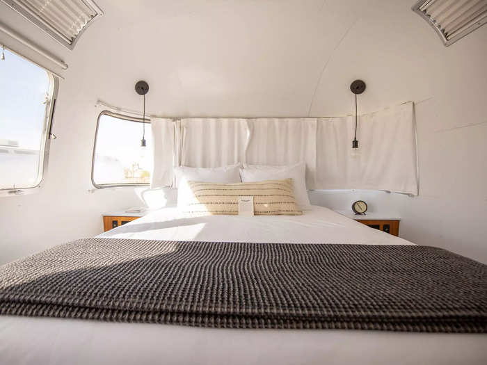 … and a window-lined bedroom with a TV and comfortable queen bed.