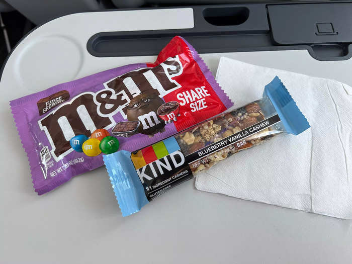 ...and fudge brownie M&Ms. The Kind bar was also complimentary, and first class passengers get one free alcoholic beverage on each flight. Travelers can buy additional alcohol.