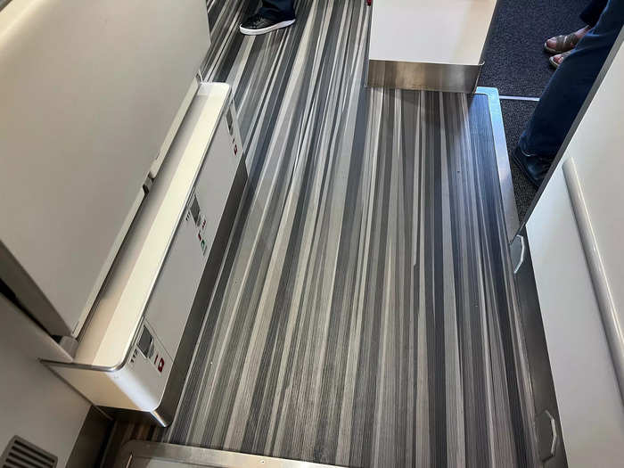 Boarding the aircraft, the first thing I noticed was the unique floor design and large galley area. The entrance felt welcoming, and the jet still had that new plane smell.