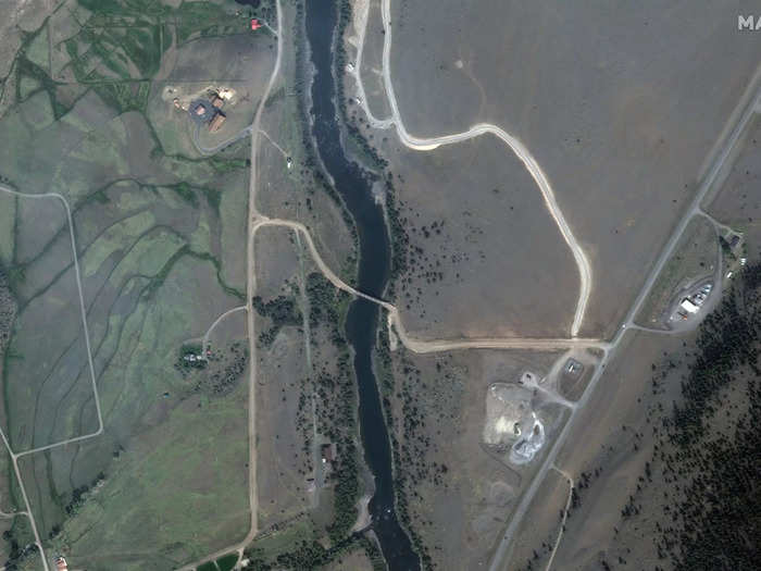 More satellite images reveal a bridge washed out over the swollen, churning Yellowstone River. Here