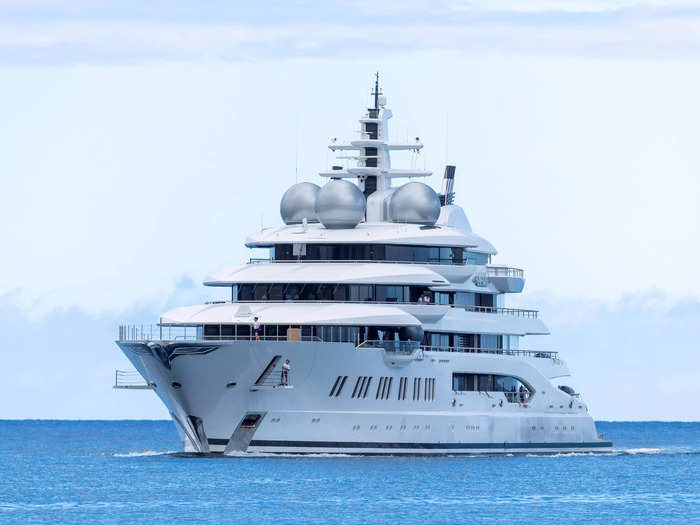 At 348 feet, the Amadea is nearly as long as a football field. The luxurious boat features a large helipad, an in-deck pool, gold detailing, and eight separate cabins.