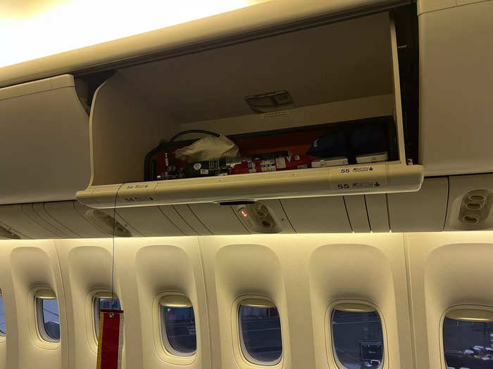 However, overhead bins were left in place, with a few holding emergency equipment, like a first aid kit and fire extinguisher.