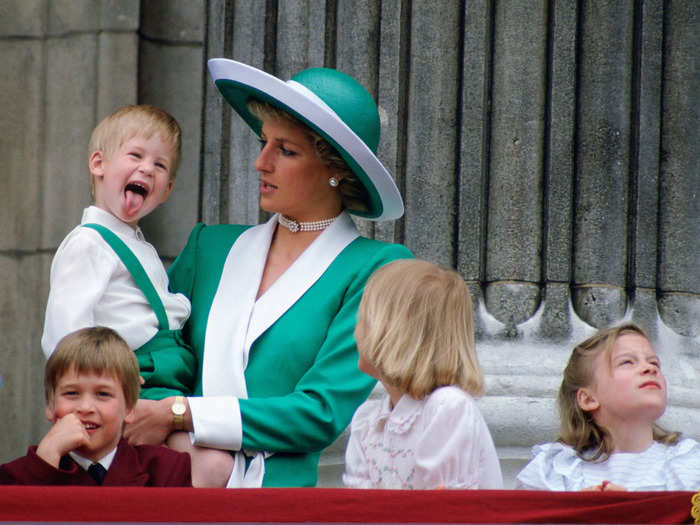 1988: The following year, he joined his mother and Prince Harry on the Buckingham Palace balcony for Trooping the Colour.