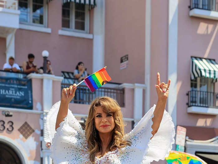 Paula Abdul rode in the back of a car in a shimmering white dress during the Los Angeles Pride parade.
