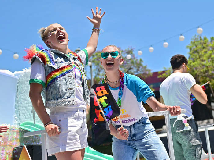 JoJo Siwa and her girlfriend Kylie Prew matched their denim and rainbow looks.
