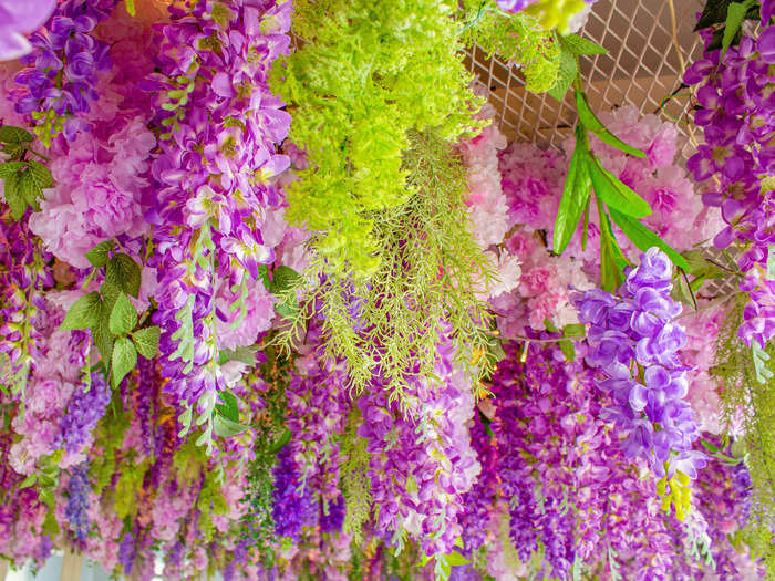 Over-the-top floral ceiling installations are trending.