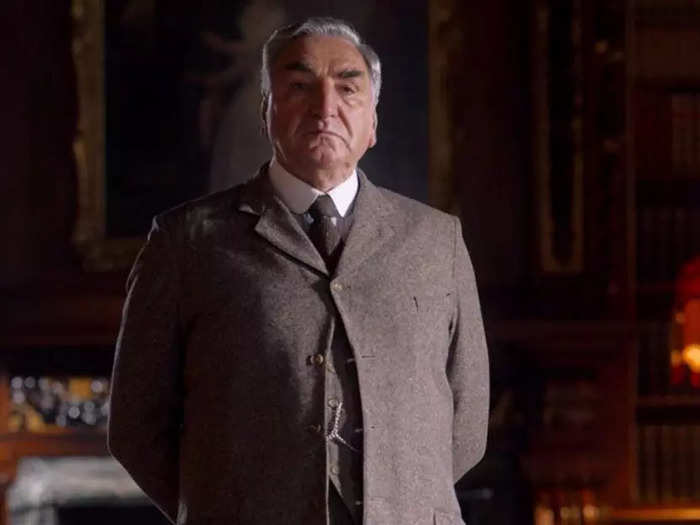 Carson wears his hair back, keeps his brow furrowed, and is fond of the heavy suits that made his character sweat constantly in "Downton Abbey: A New Era."