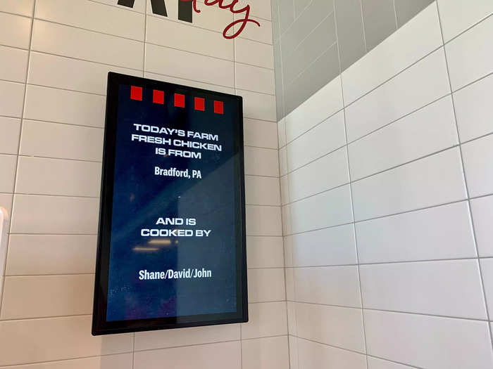 In addition to digital menu boards, another digital screen displayed information about where the chickens were from and who was preparing them.