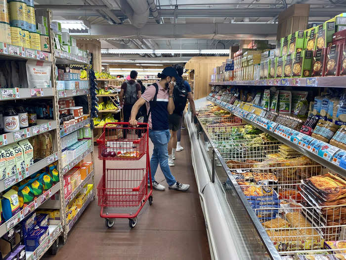 Shoppers often blocked the pathways with their carts as they browsed the variety of food options.