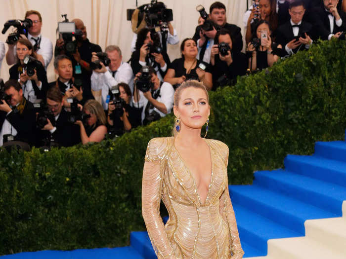 Lively turned heads at the 2017 Met Gala in a gorgeous Atelier Versace gown that had a dramatic feather train and sheer gold fringe along her arms.