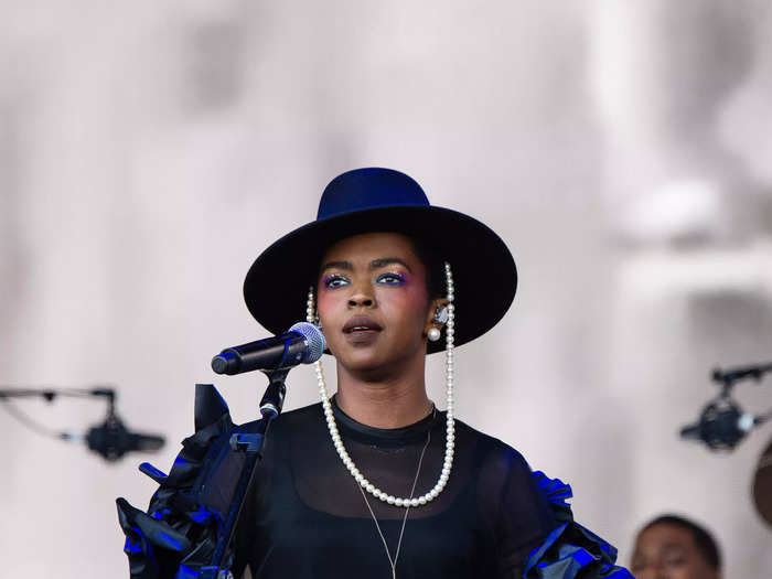 At the 2019 festival, Lauryn Hill looked chic in high-waisted pants, a sheer top with dramatic ruffles, and a hat with a pearl strap.