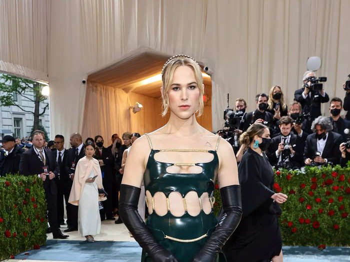 Tommy Dorman made her Met Gala debut in a dark emerald rubber gown with cut-out detailing.