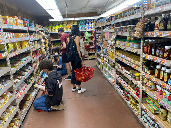 Some Trader Joe’s employees were stocking shelves, causing the small path to be even more packed than before.