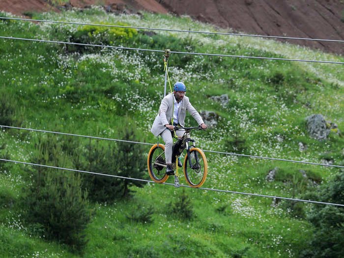 Daredevils like this visitor can bicycle over the canyon on the zipline, which runs parallel to the bridge.