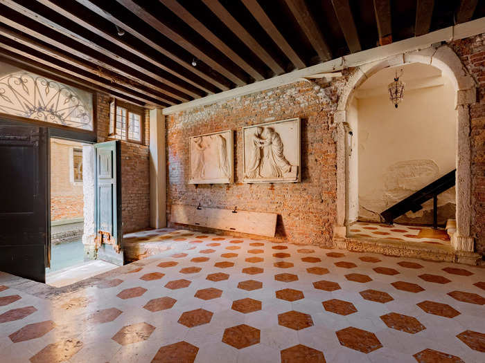 Many historical features of the home have been preserved, including beamed ceilings, terrazzo tile floors, and red brick walls.