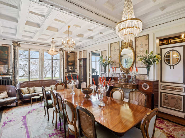 The dining area is outfitted with three chandeliers and a 12-seater table.