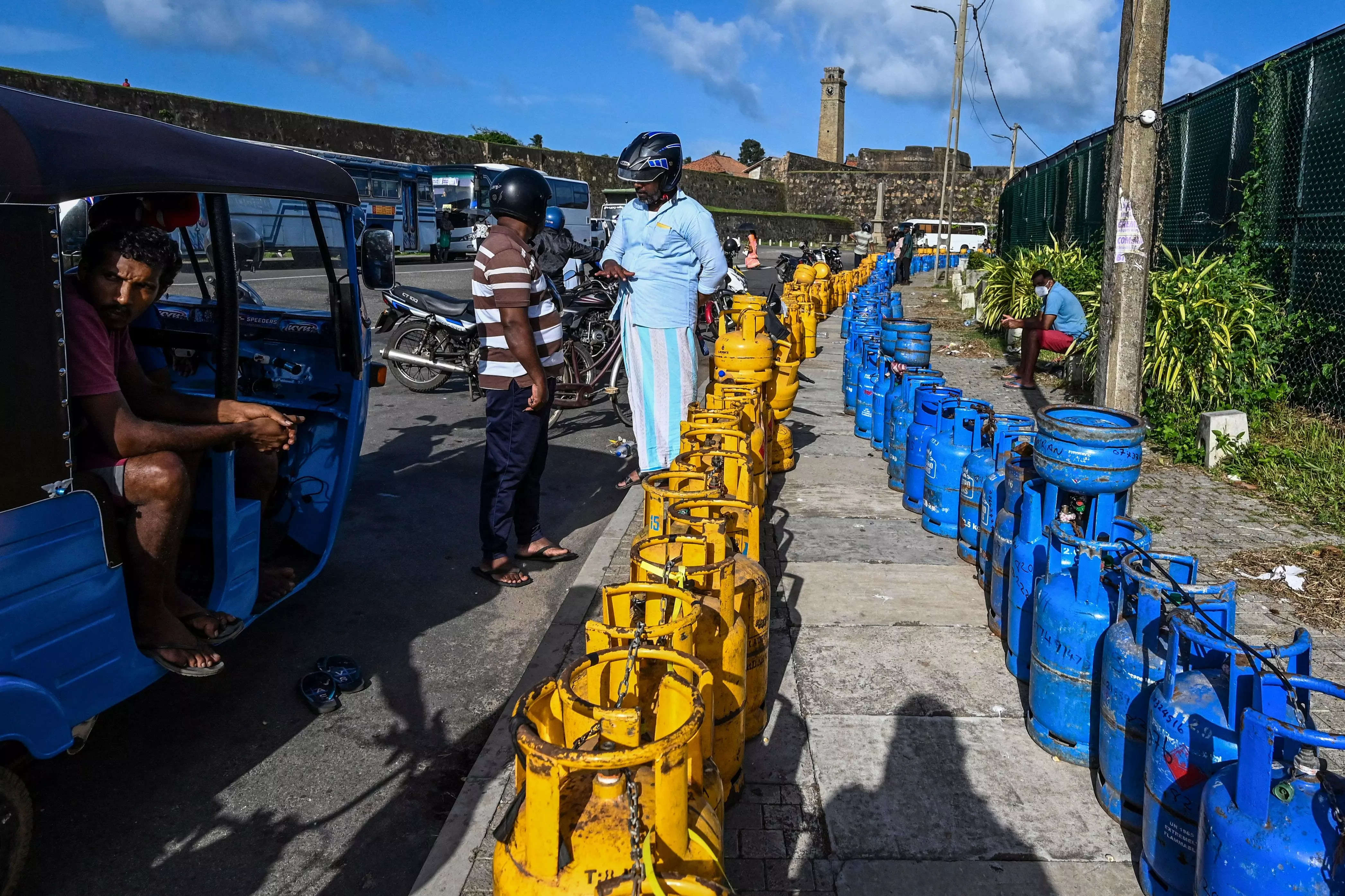 People to buy Liquefied Petroleum Gas (LPG) cylinders near the Galle International Cricket Stadium in Galle on June 28, 2022.