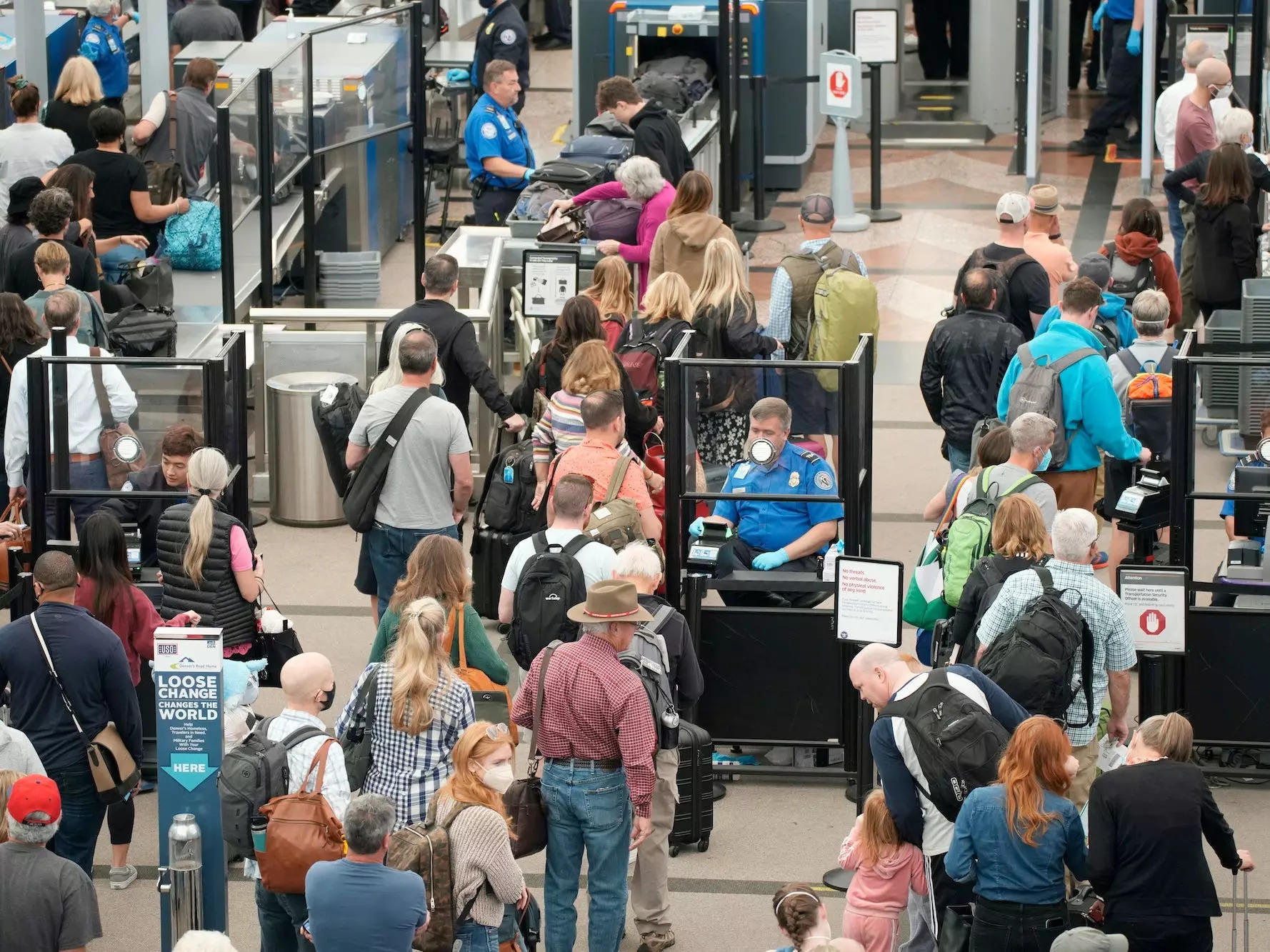 Travelers queue up move through the north security checkpoint in the main terminal of Denver International Airport