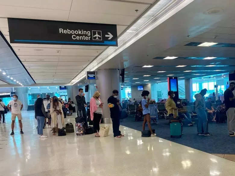 Passengers in line in Miami to rebook canceled American Airlines flights in 2021.