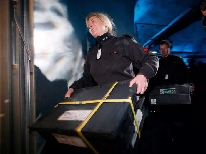 Inside, seeds are moved to a trolley and rolled into the vault