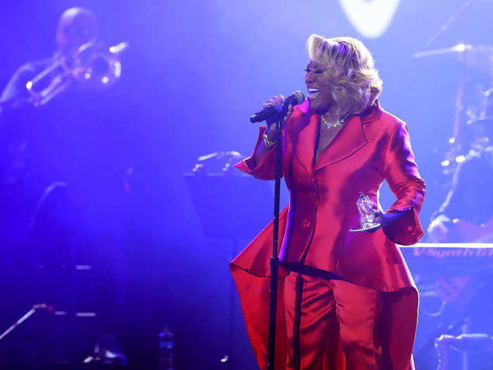 Patti LaBelle stunned in a silky red power suit.