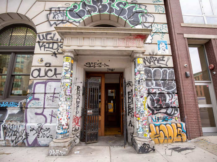 The label-less entrance is covered in graffiti.