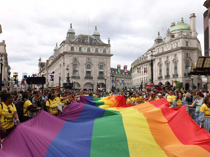 Members and supporters of the LGBTQ community carried a massive rainbow flag through the crowds.