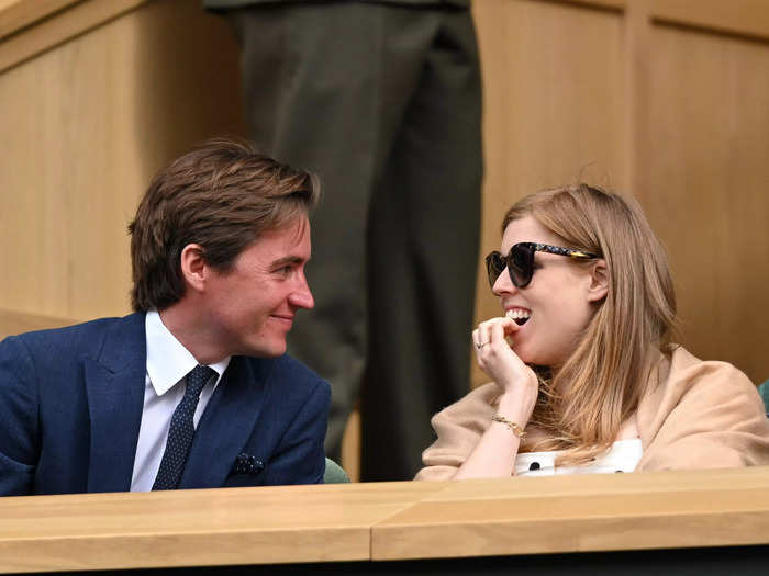 Princess Beatrice, then pregnant with her daughter Sienna, and her husband Edo Mapelli Mozzi share an endearing moment while spectating Wimbledon in 2021.